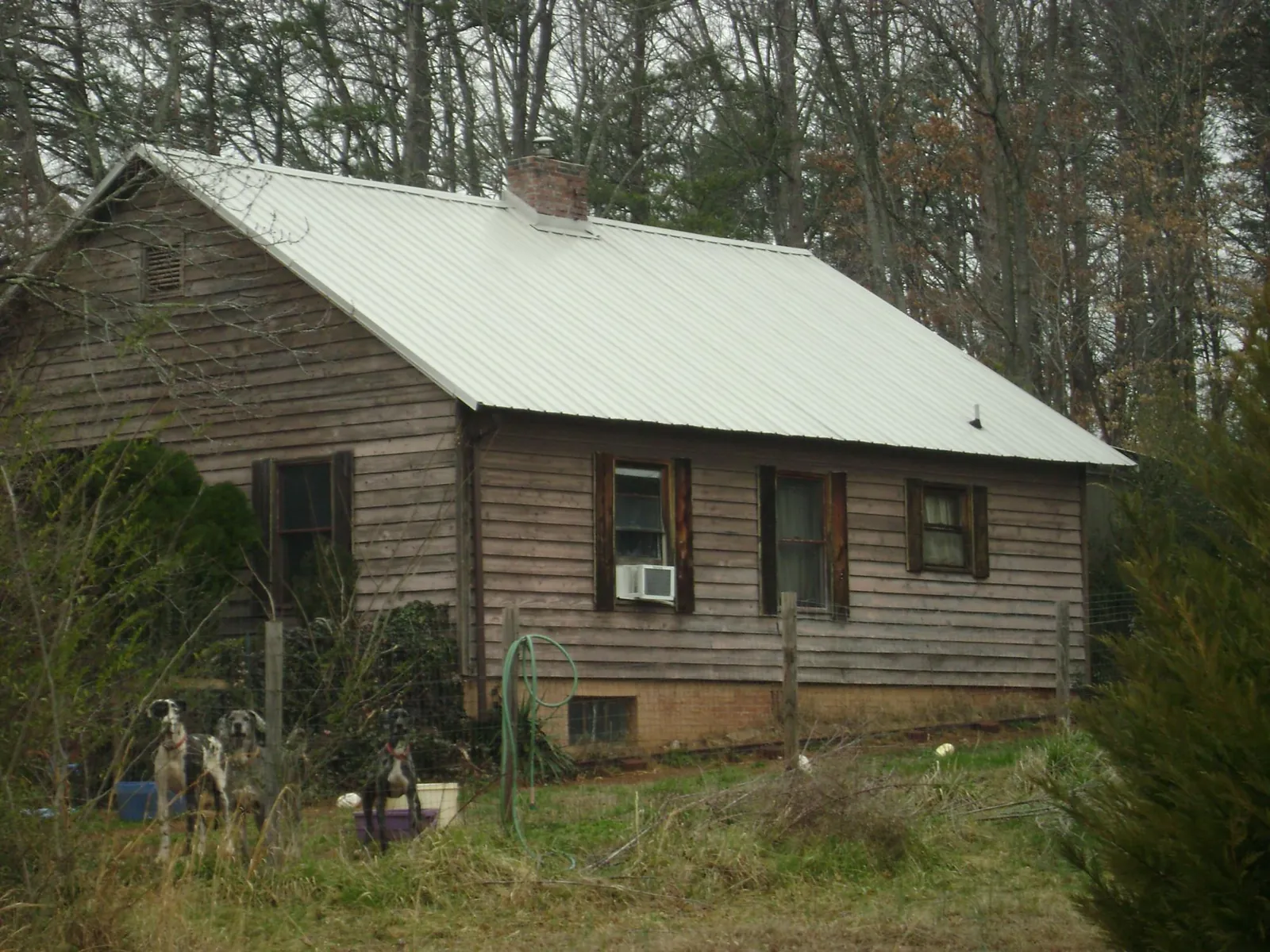 White metal roof on an old wood sided farmhouse, from a Metal Roof Installation job in New Fairfield
